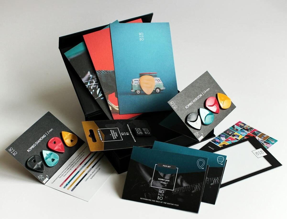 Colorful Rombo guitar picks arranged with packaging for a vibrant display.